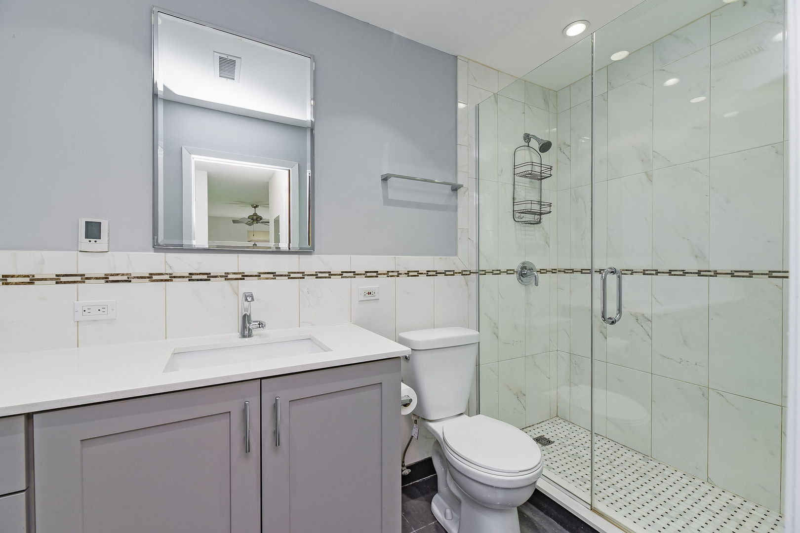 1464 Stonebridge Circle, Unit E3 Wheaton, IL 60189 - Photo 9 of 9 a bathroom with a granite countertop sink a toilet and a mirror
