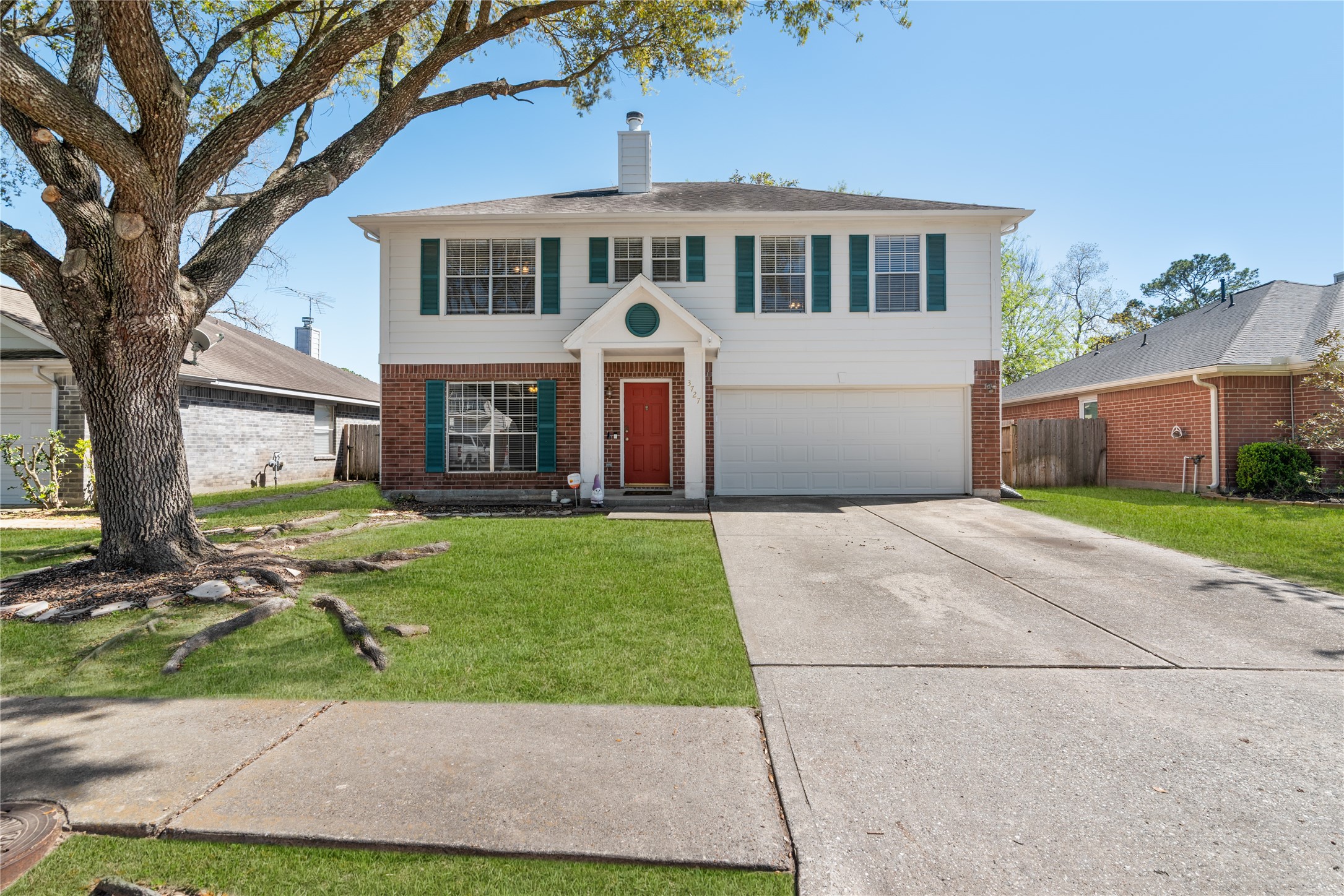 3727 Oaklace Drive Spring, TX 77389 - Photo 2 of 37 a front view of a house with a yard and garage