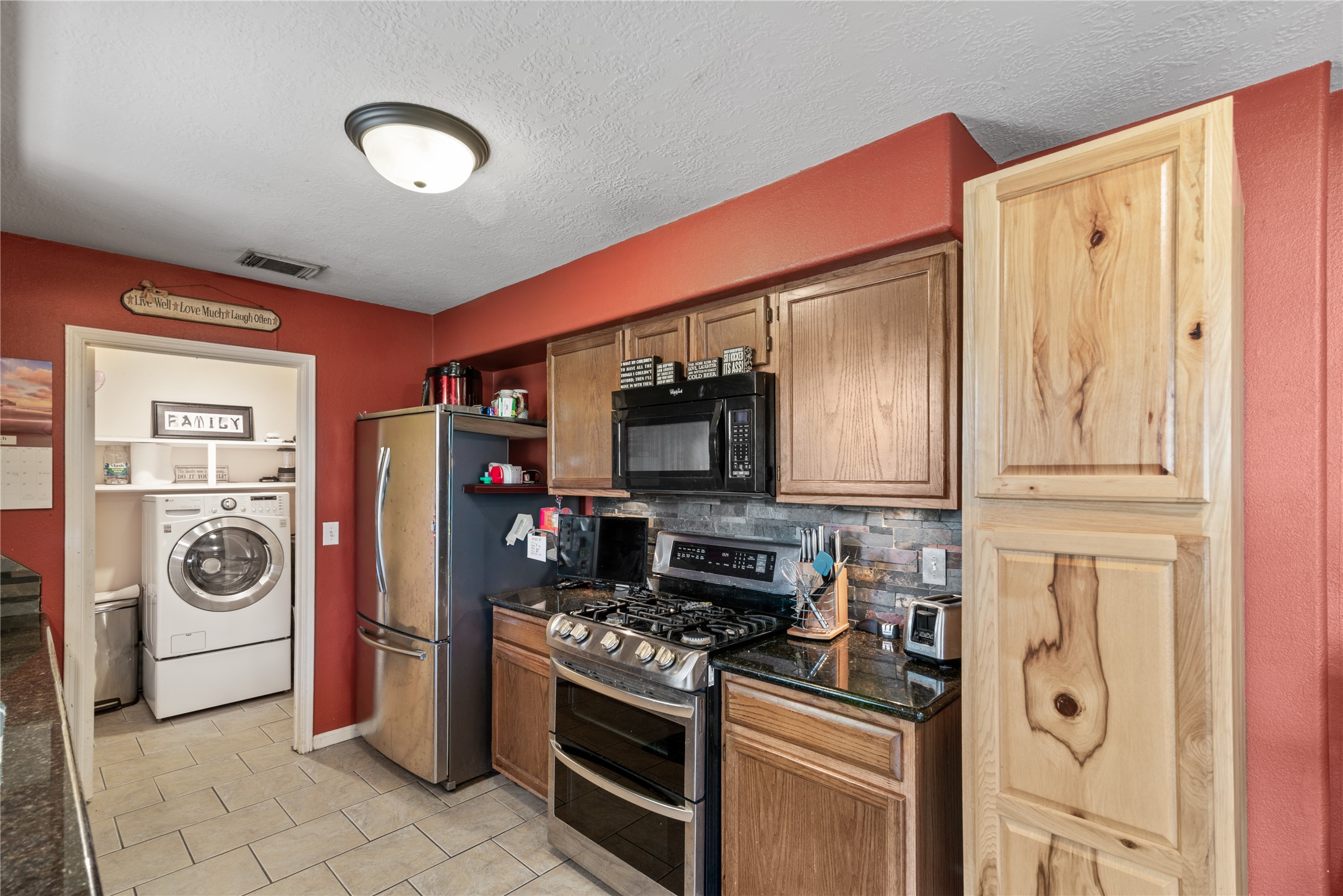 3727 Oaklace Drive Spring, TX 77389 - Photo 7 of 37 a kitchen with stainless steel appliances granite countertop a stove and a refrigerator