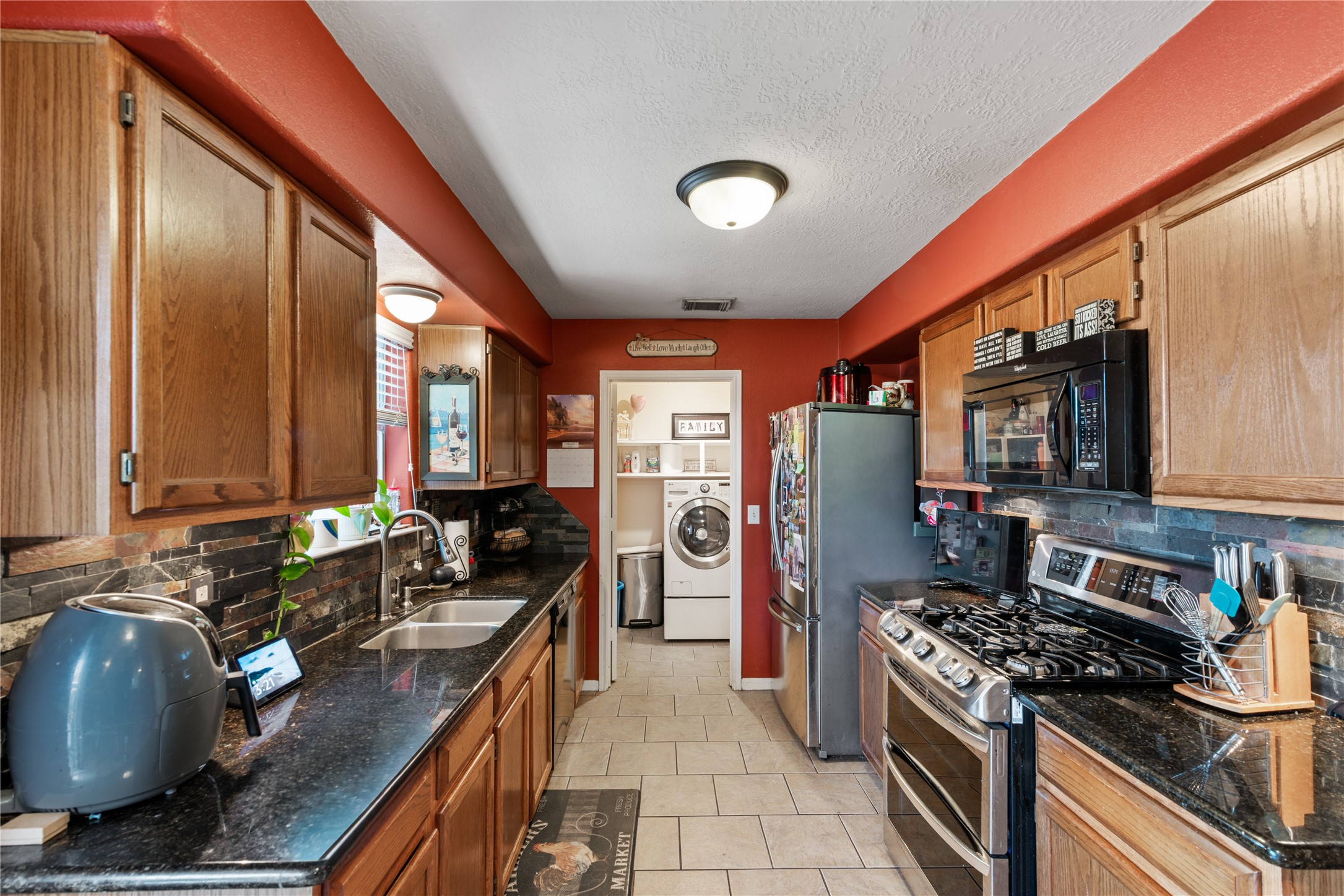 3727 Oaklace Drive Spring, TX 77389 - Photo 8 of 37 a kitchen with stainless steel appliances granite countertop a stove a sink and a refrigerator