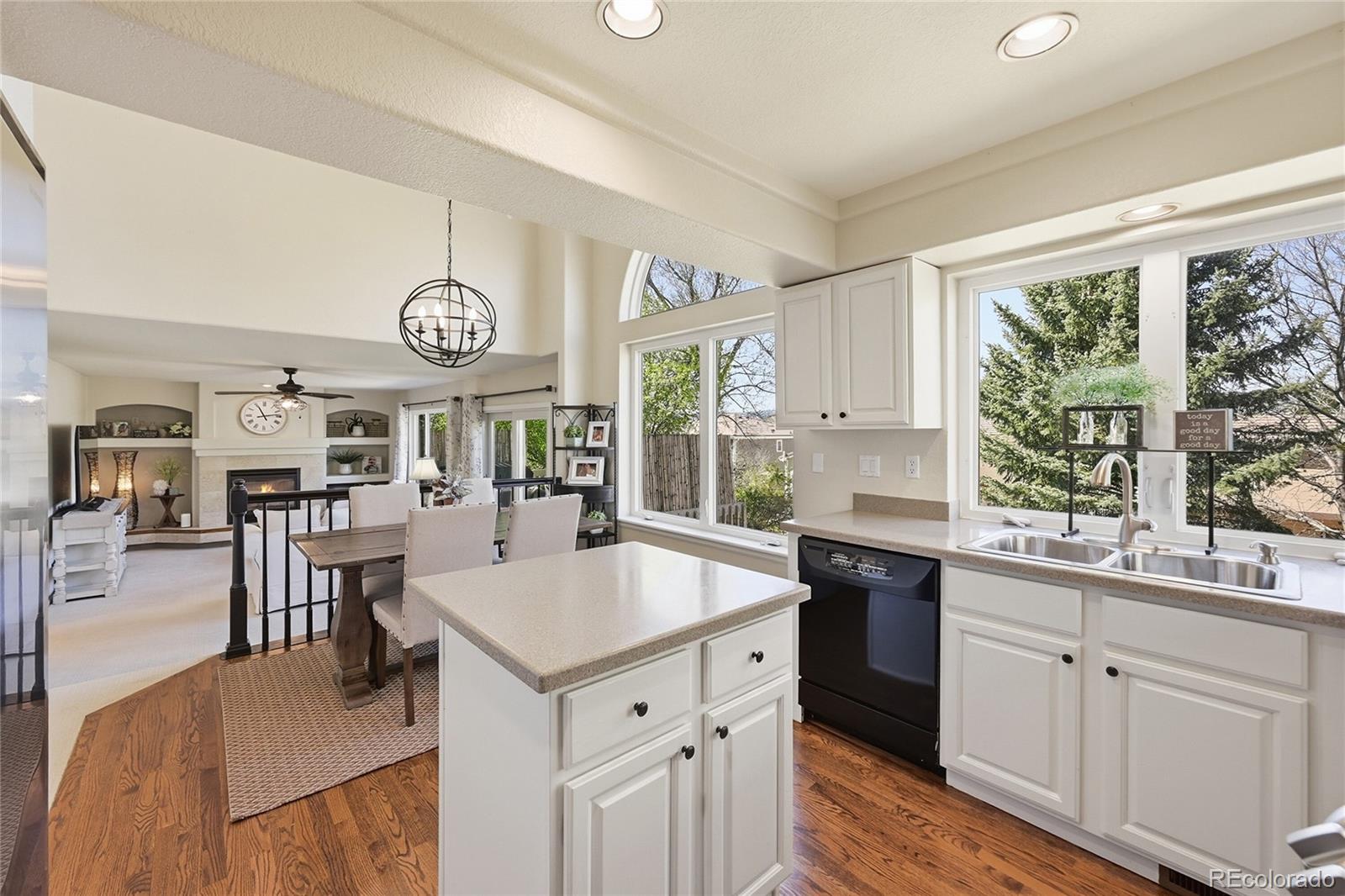 9153 Roadrunner Drive Highlands Ranch, CO 80129 - Photo 15 of 39 a large kitchen with a large counter space and wooden floor
