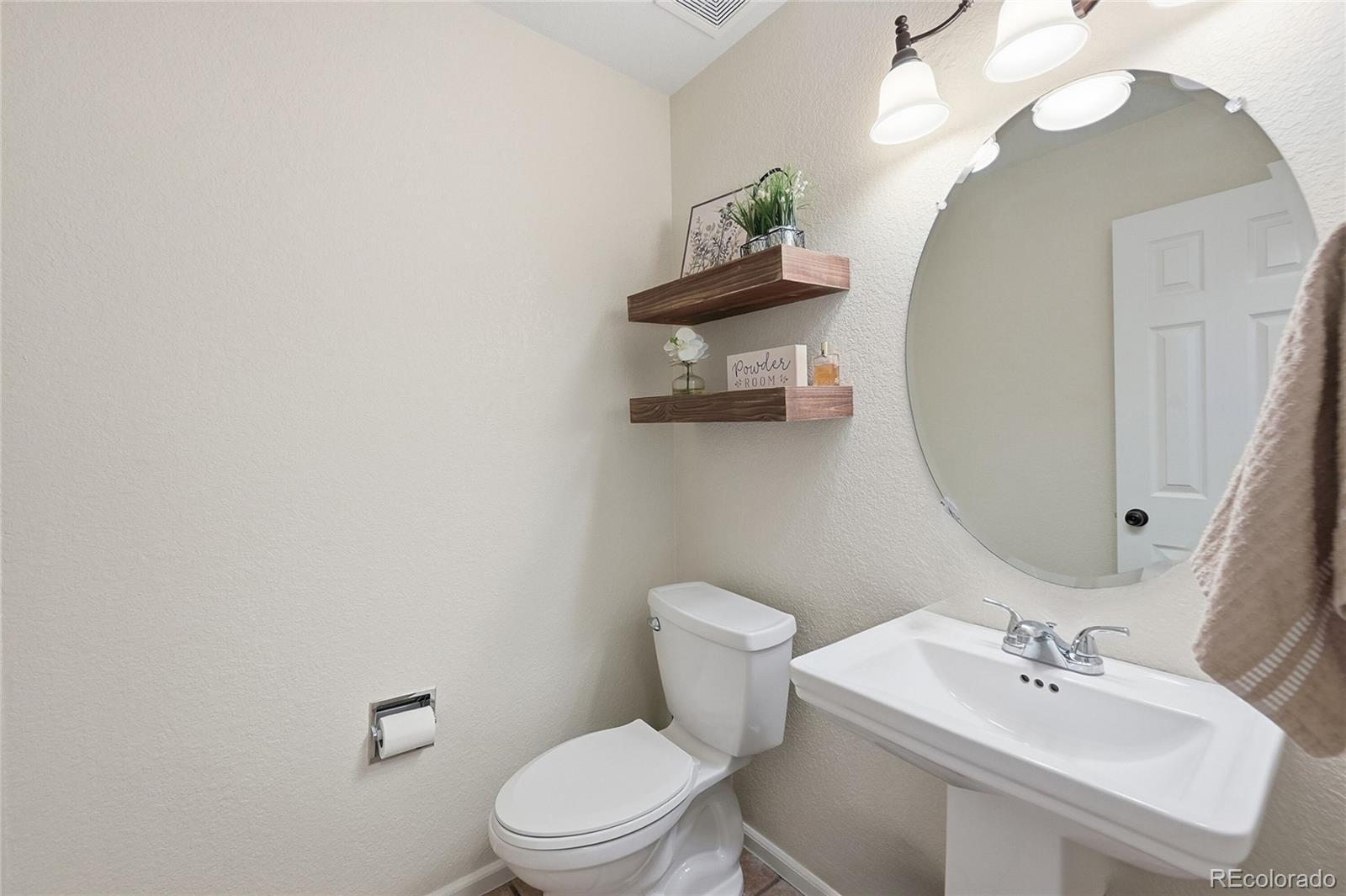 9153 Roadrunner Drive Highlands Ranch, CO 80129 - Photo 18 of 39 a bathroom with a sink mirror and toilet