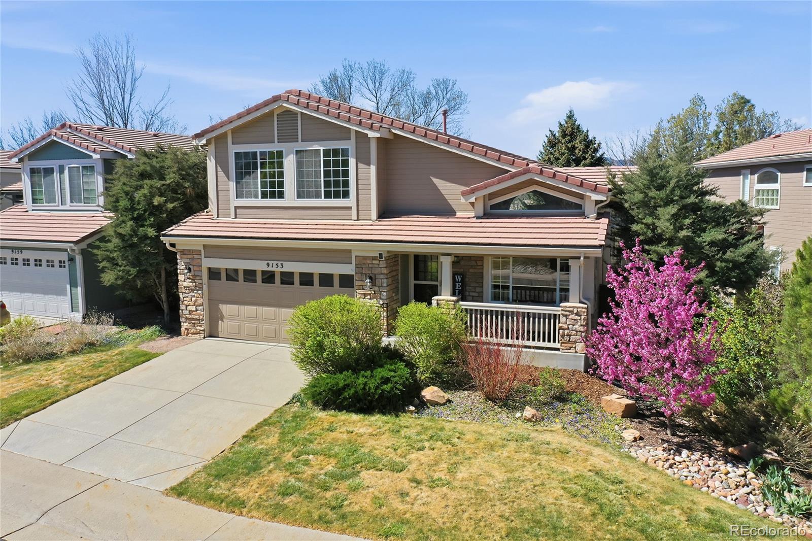 9153 Roadrunner Drive Highlands Ranch, CO 80129 - Photo 2 of 39 a front view of a house with a yard