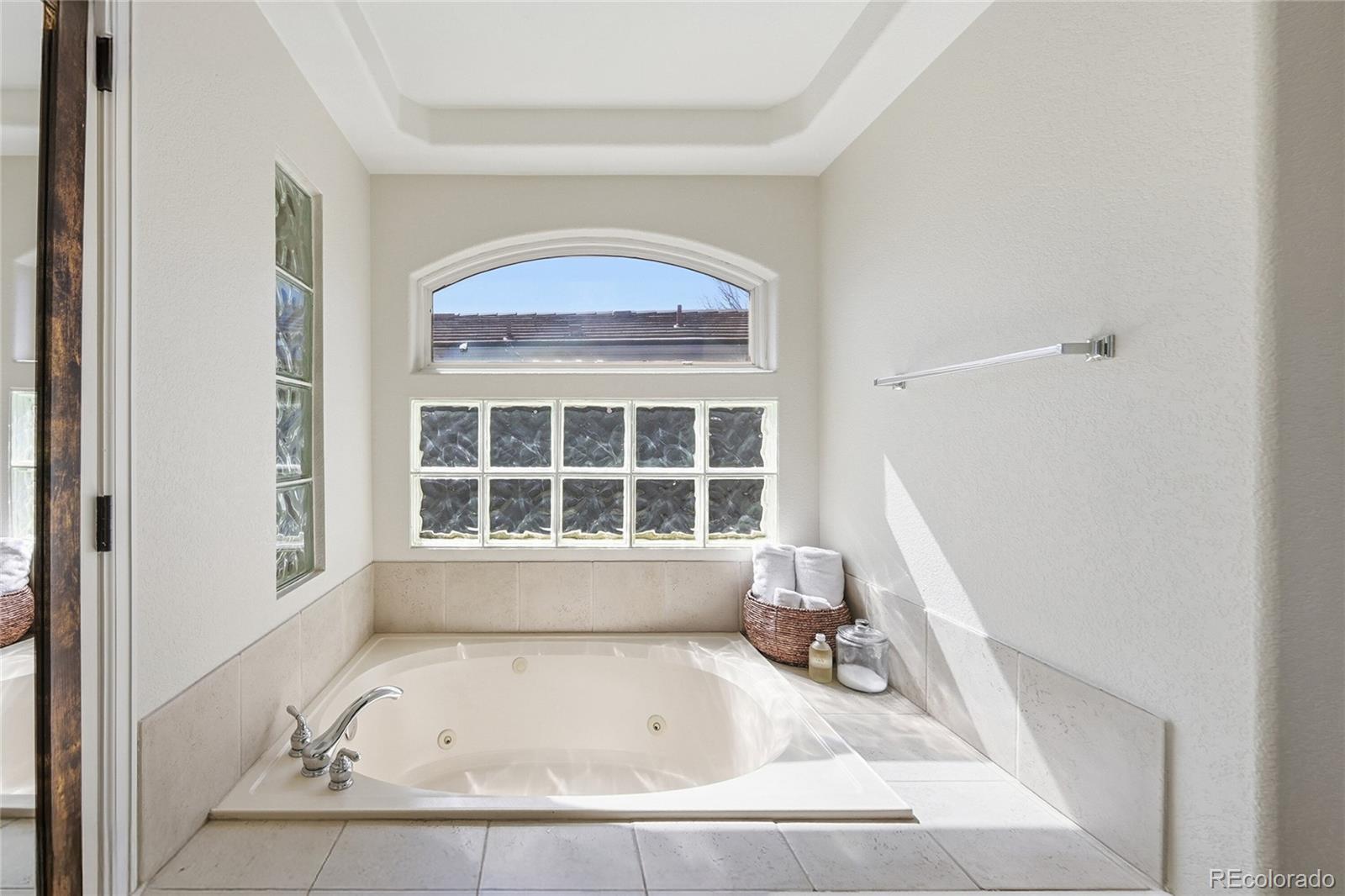 9153 Roadrunner Drive Highlands Ranch, CO 80129 - Photo 24 of 39 a bath tub sitting in a bathroom next to a window