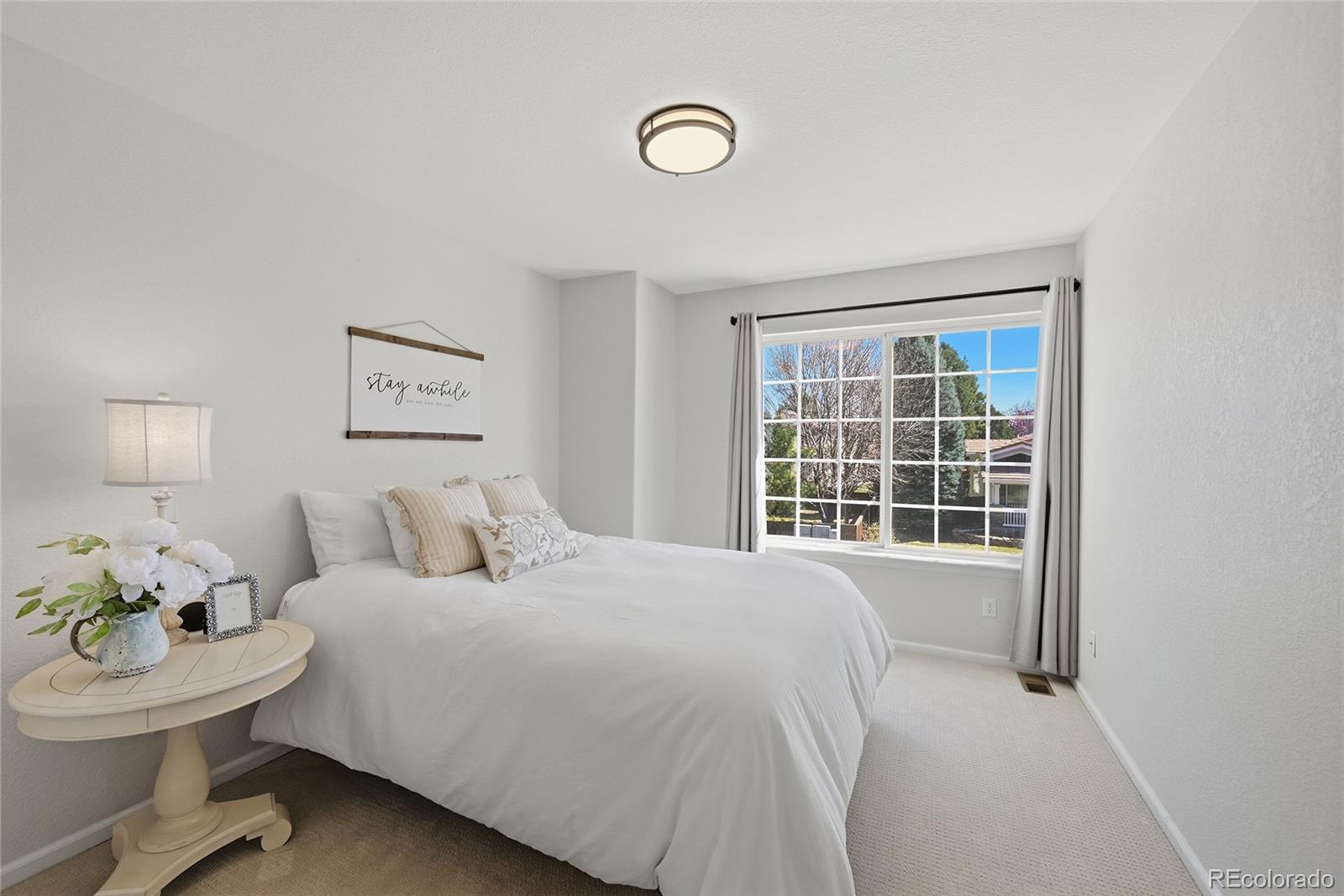 9153 Roadrunner Drive Highlands Ranch, CO 80129 - Photo 28 of 39 a bedroom with a bed and a window