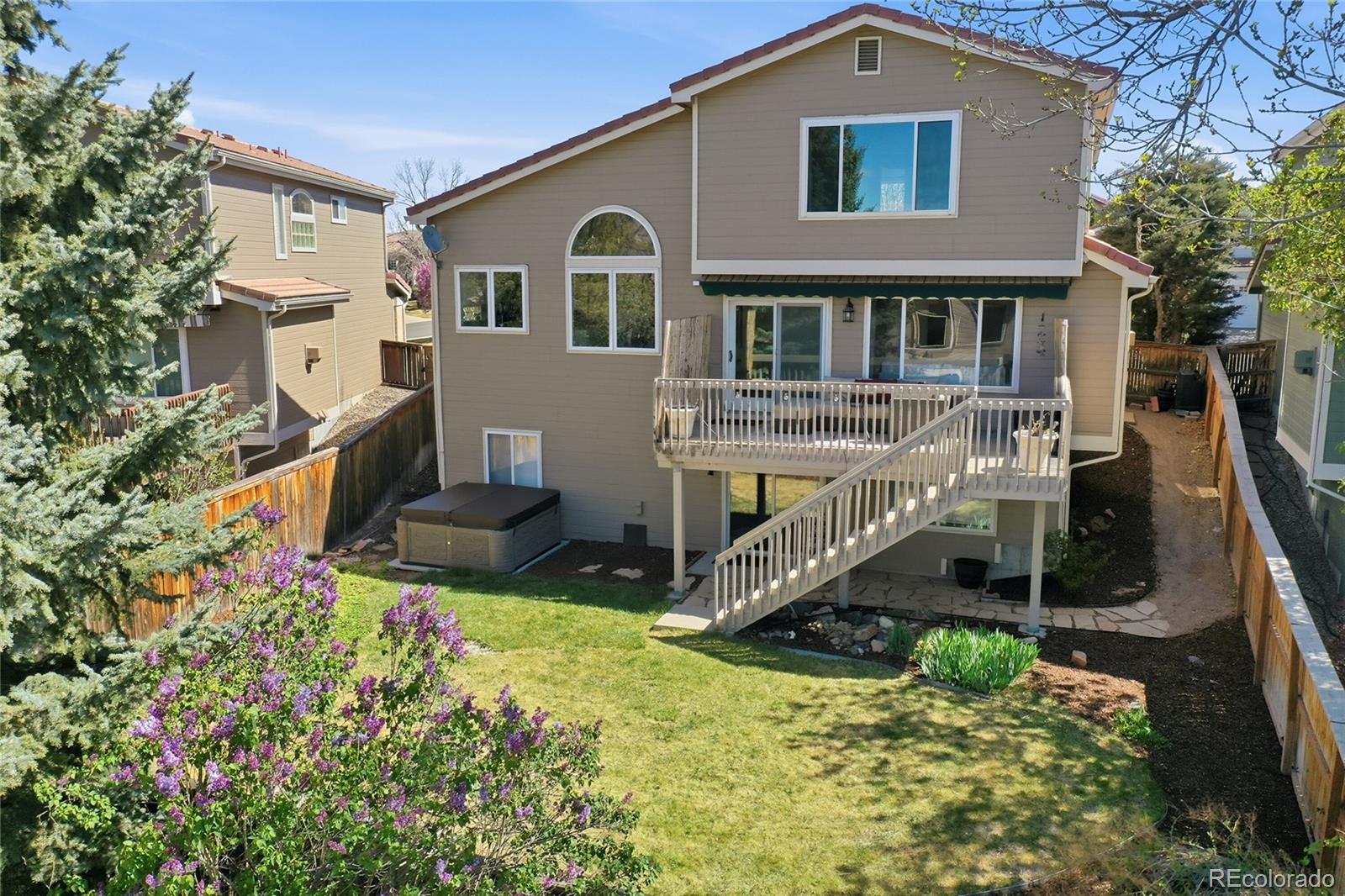 9153 Roadrunner Drive Highlands Ranch, CO 80129 - Photo 36 of 39 a front view of a house with yard and green space