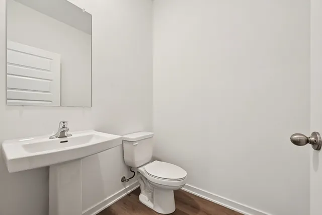 a white toilet sitting next to a white sink