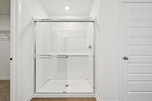 a bathroom with a glass shower door