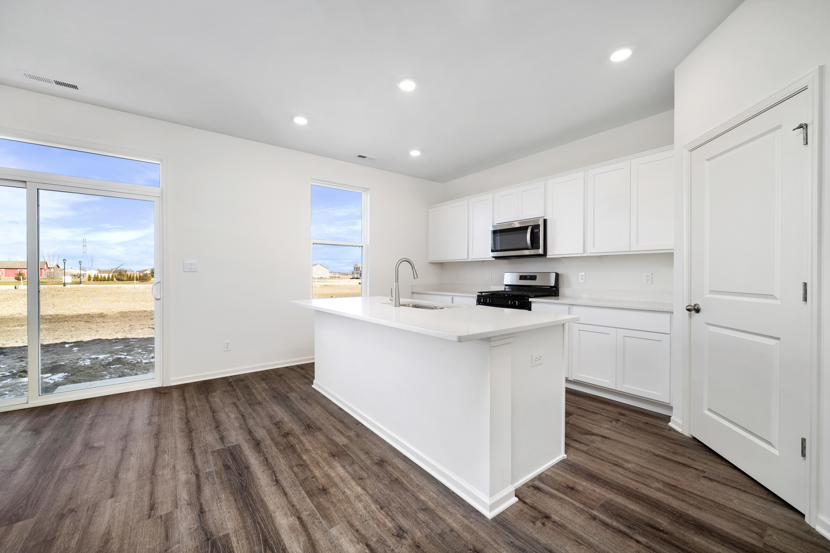 3000 Old Castle Road Joliet, IL 60435 - Photo 6 of 30 a kitchen with a hard wood floor white cabinets and wooden floor