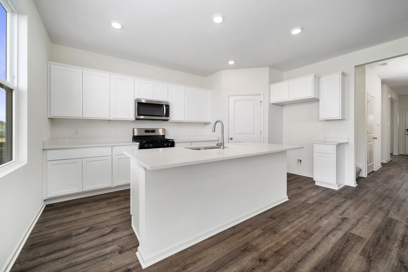 3000 Old Castle Road Joliet, IL 60435 - Photo 8 of 30 a kitchen with stainless steel appliances white cabinets a sink a stove a refrigerator and a microwave