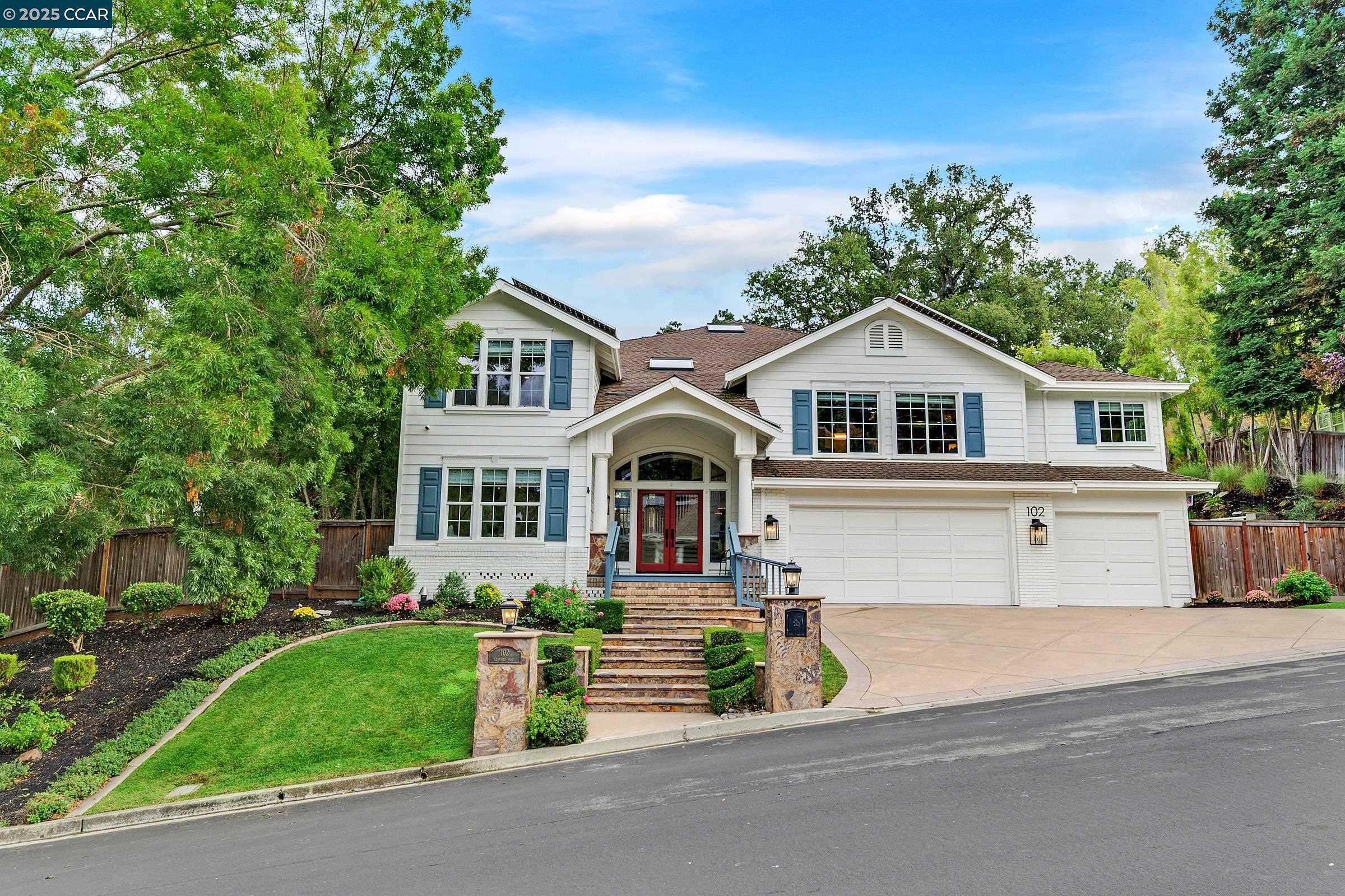 a front view of a house with a garden