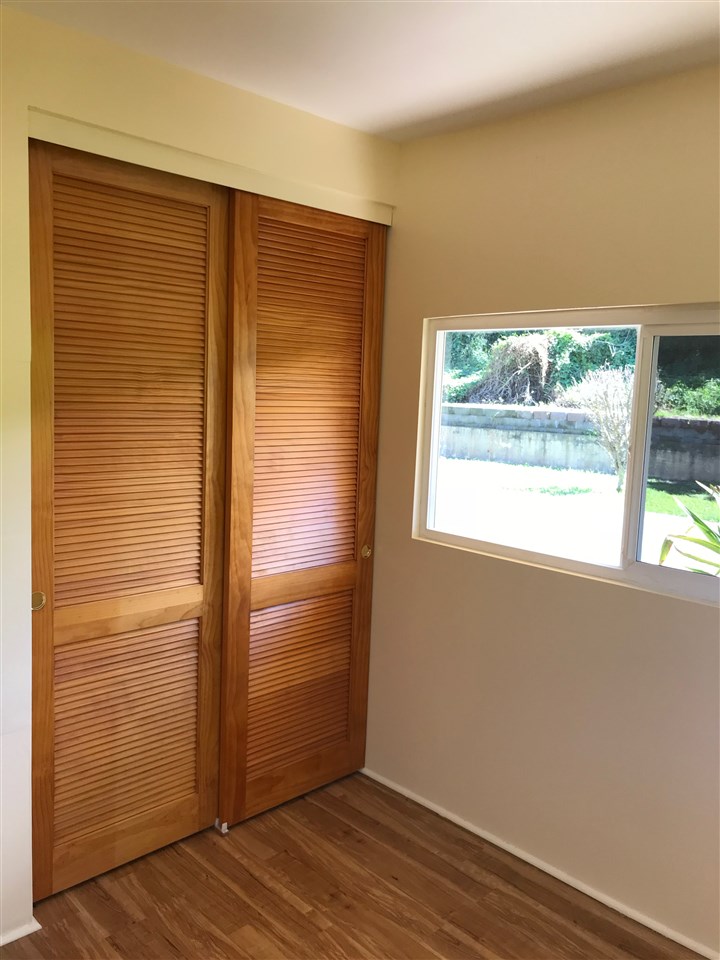 447 Ainakula Road, Unit 9A Kula, HI 96790 - Photo 8 of 27 an empty room with wooden floor and windows