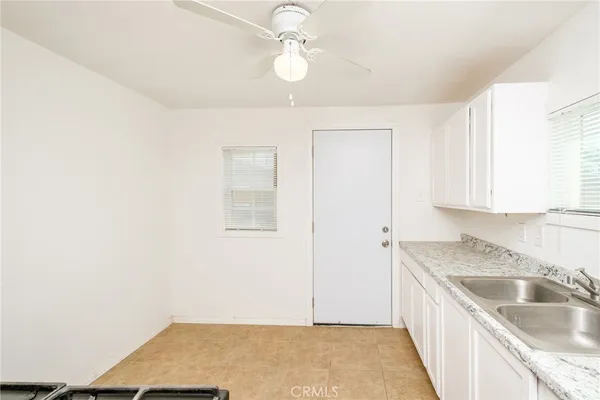 a kitchen with granite countertop a sink and a stove
