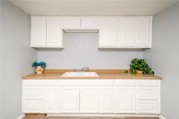 a view of a big room with closet and a chandelier fan