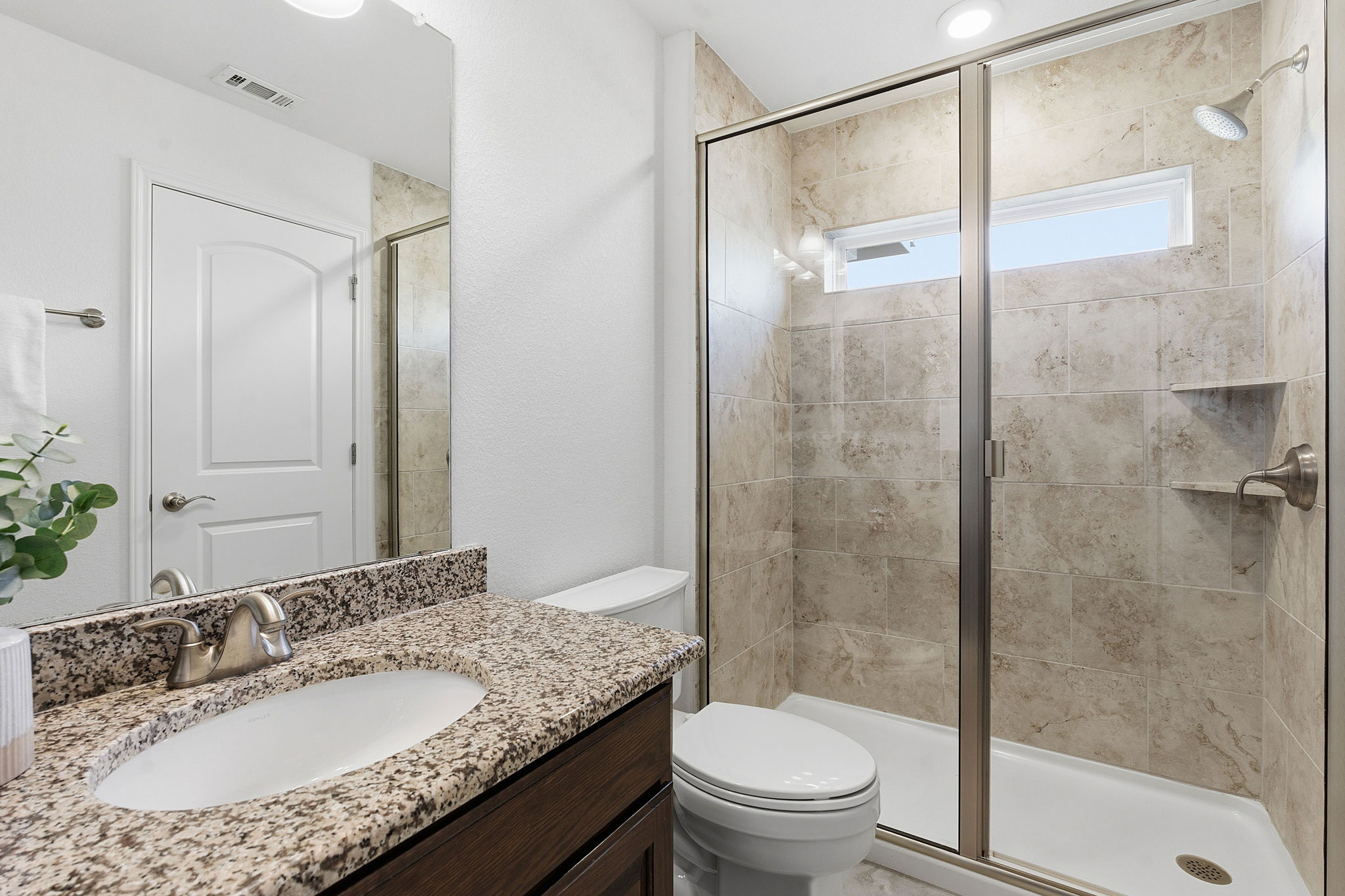 2824 Wedgescale Pass Leander, TX 78641 - Photo 25 of 40 Private bathroom in the second primary suite on the main level with walk-in shower for long term guests