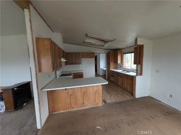 a view of kitchen with sink microwave and refrigerator
