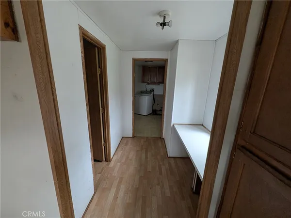 a view of a hallway and wooden floor