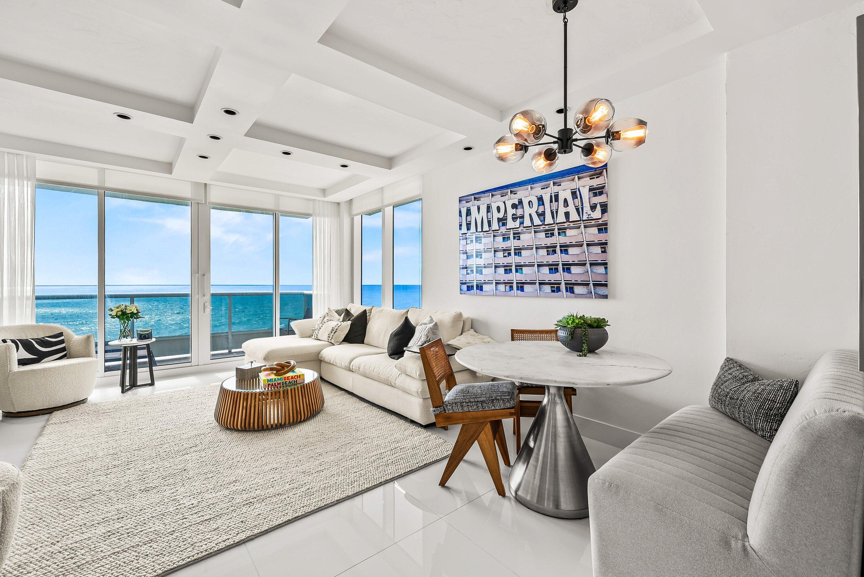 700 South Ocean Boulevard, Unit 705 Boca Raton, FL 33432 - Photo 25 of 58 a living room with furniture and a chandelier