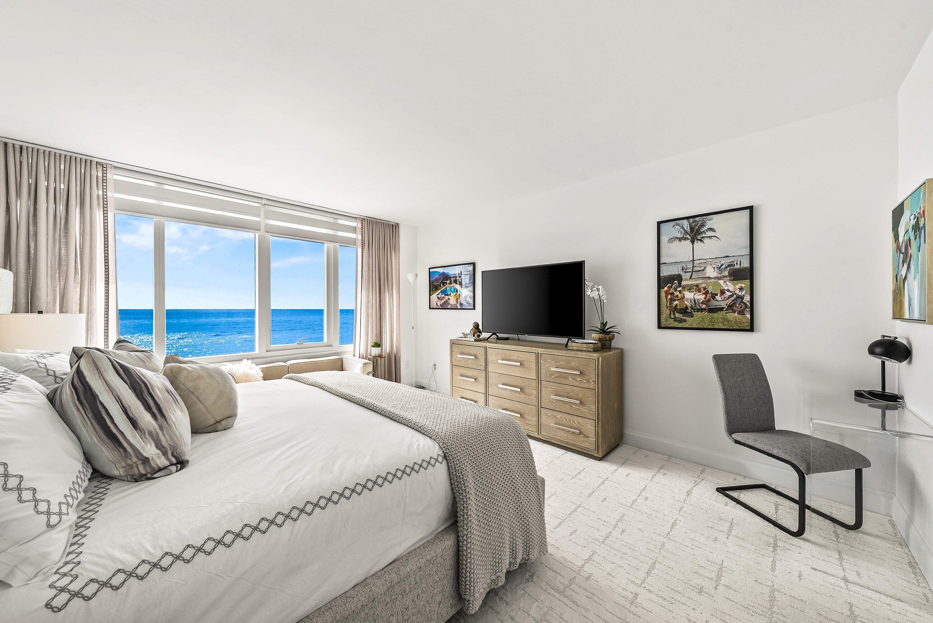 700 South Ocean Boulevard, Unit 705 Boca Raton, FL 33432 - Photo 26 of 58 a bedroom with a bed and a flat screen tv
