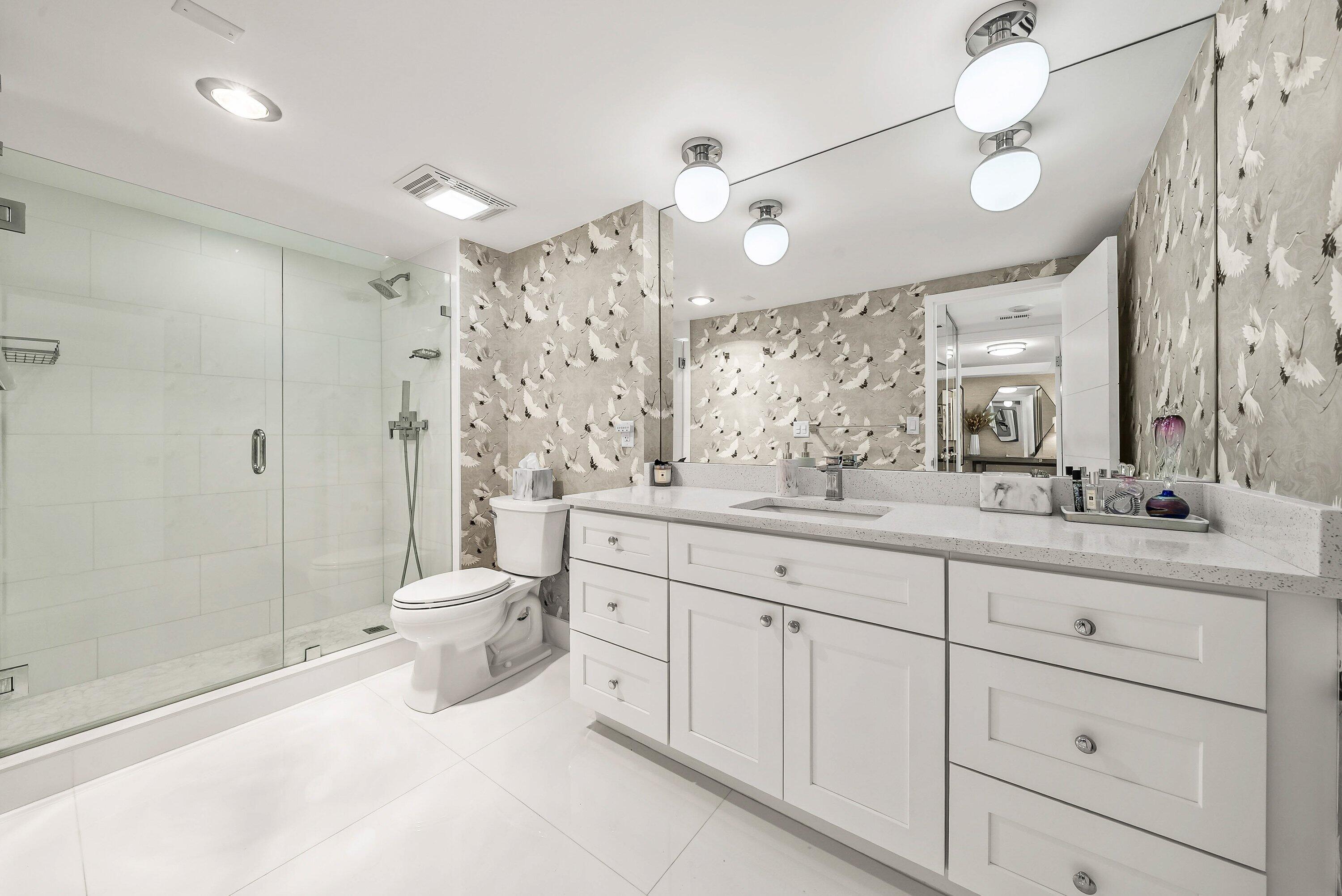 700 South Ocean Boulevard, Unit 705 Boca Raton, FL 33432 - Photo 5 of 58 a spacious bathroom with a double vanity sink toilet mirror and shower