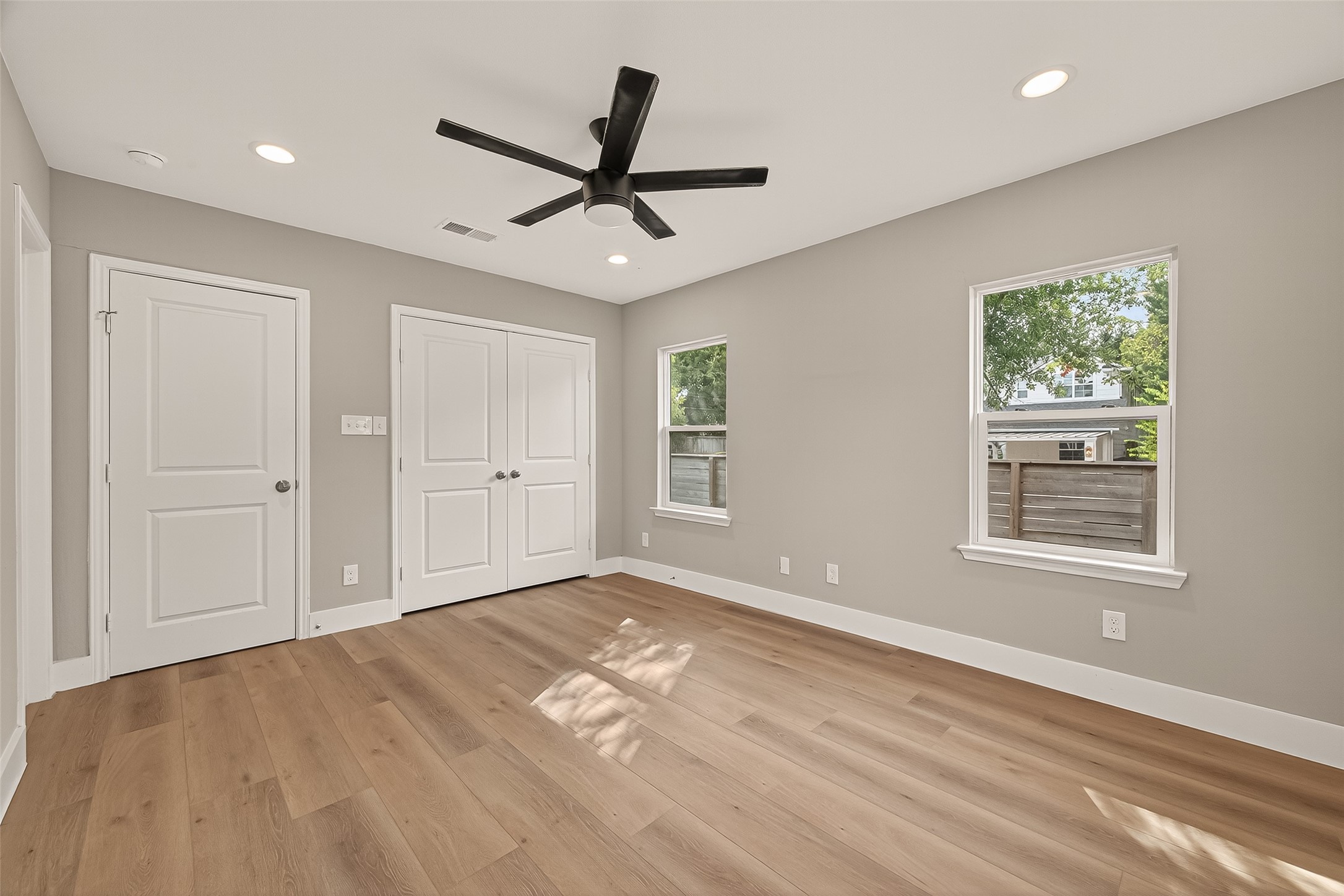 802 Nashua Street Houston, TX 77008 - Photo 11 of 16 a view of empty room with wooden floor and window