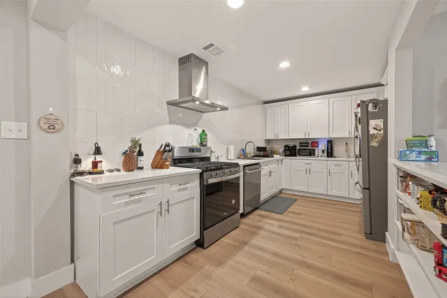 a kitchen with cabinets a sink and appliances