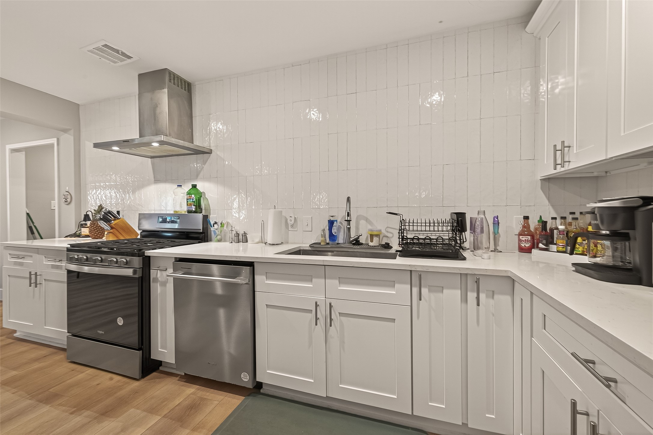 802 Nashua Street Houston, TX 77008 - Photo 6 of 16 a kitchen with white cabinets and sink