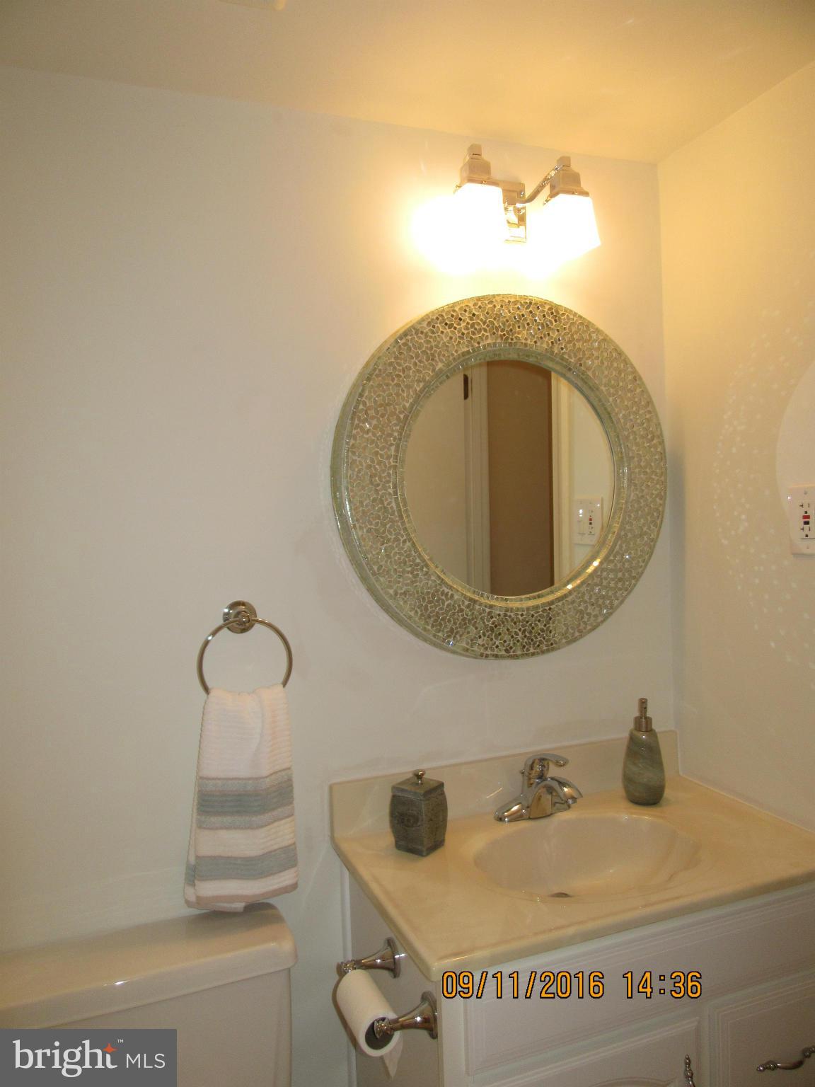 8638 Woodview Drive Springfield, VA 22153 - Photo 25 of 30 a bathroom with a sink and mirror