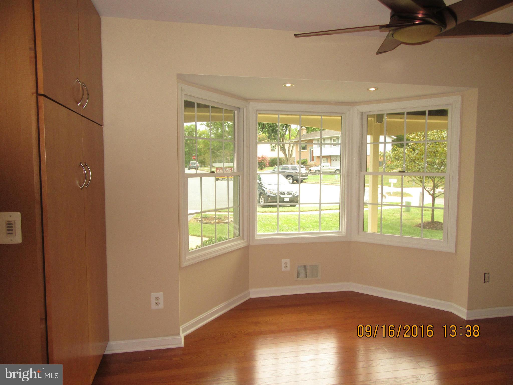 8638 Woodview Drive Springfield, VA 22153 - Photo 8 of 30 an empty room with wooden floor and windows