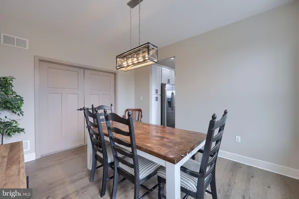 a view of a dining room a table and chairs