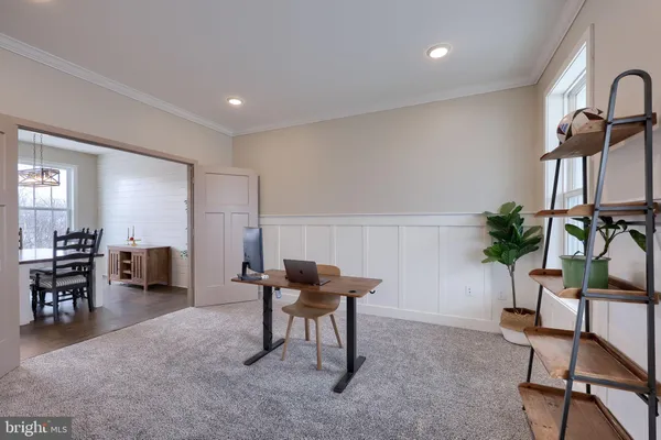 a workspace with furniture and a potted plant