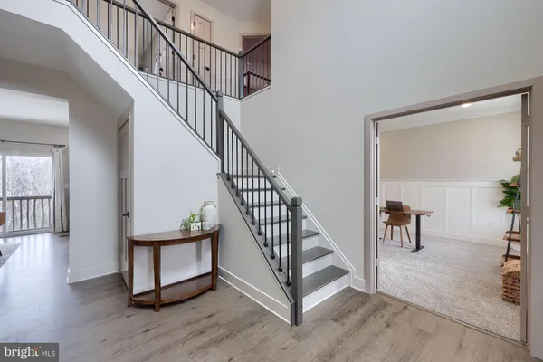 a view of staircase with white walls and a window