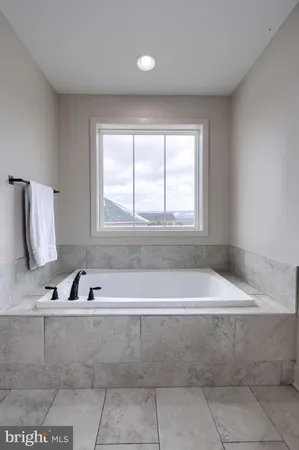 a bathroom with a bathtub and a window