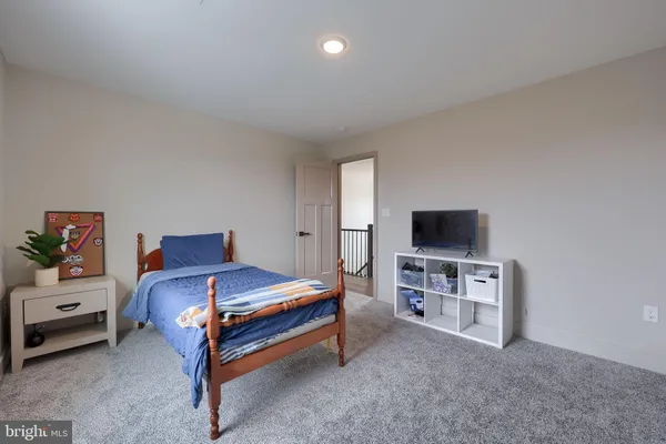 a bedroom with furniture and a flat screen tv