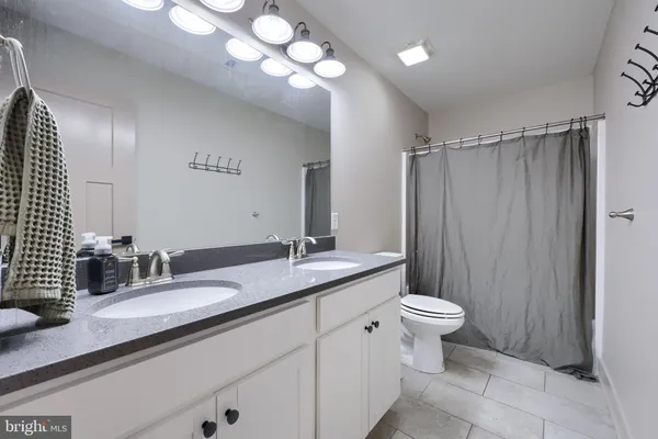 a bathroom with a double vanity sink and a mirror