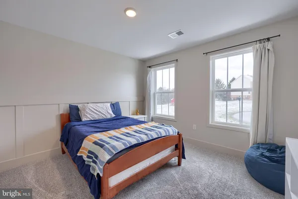 a spacious bedroom with a bed and window