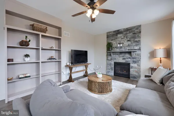 a living room with furniture and a fireplace