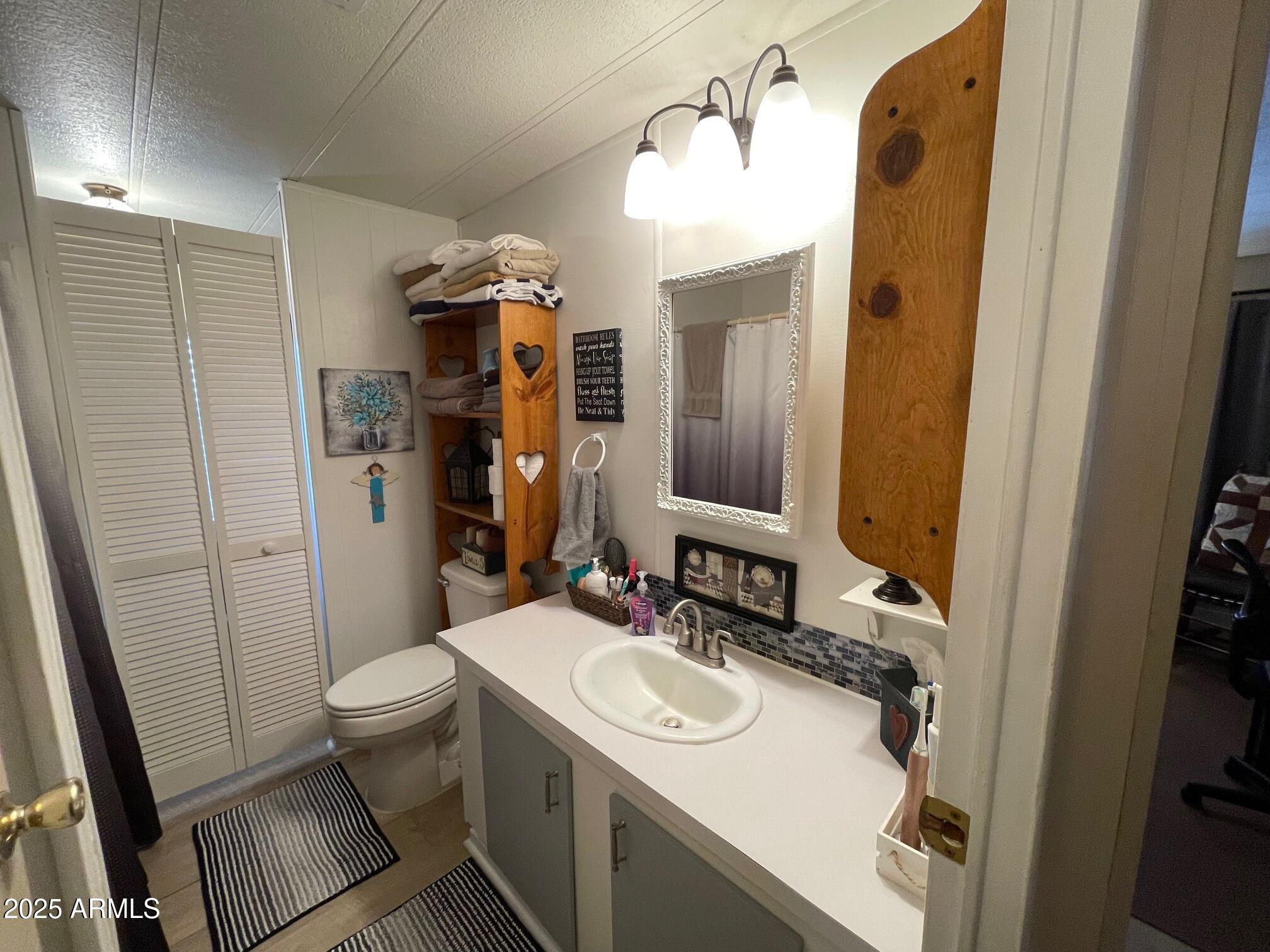 980 East Broadway Avenue, Unit 15 Apache Junction, AZ 85119 - Photo 14 of 24 a bathroom with a sink toilet and shower