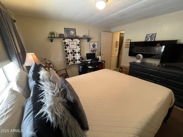 a bed room with a bed and a television