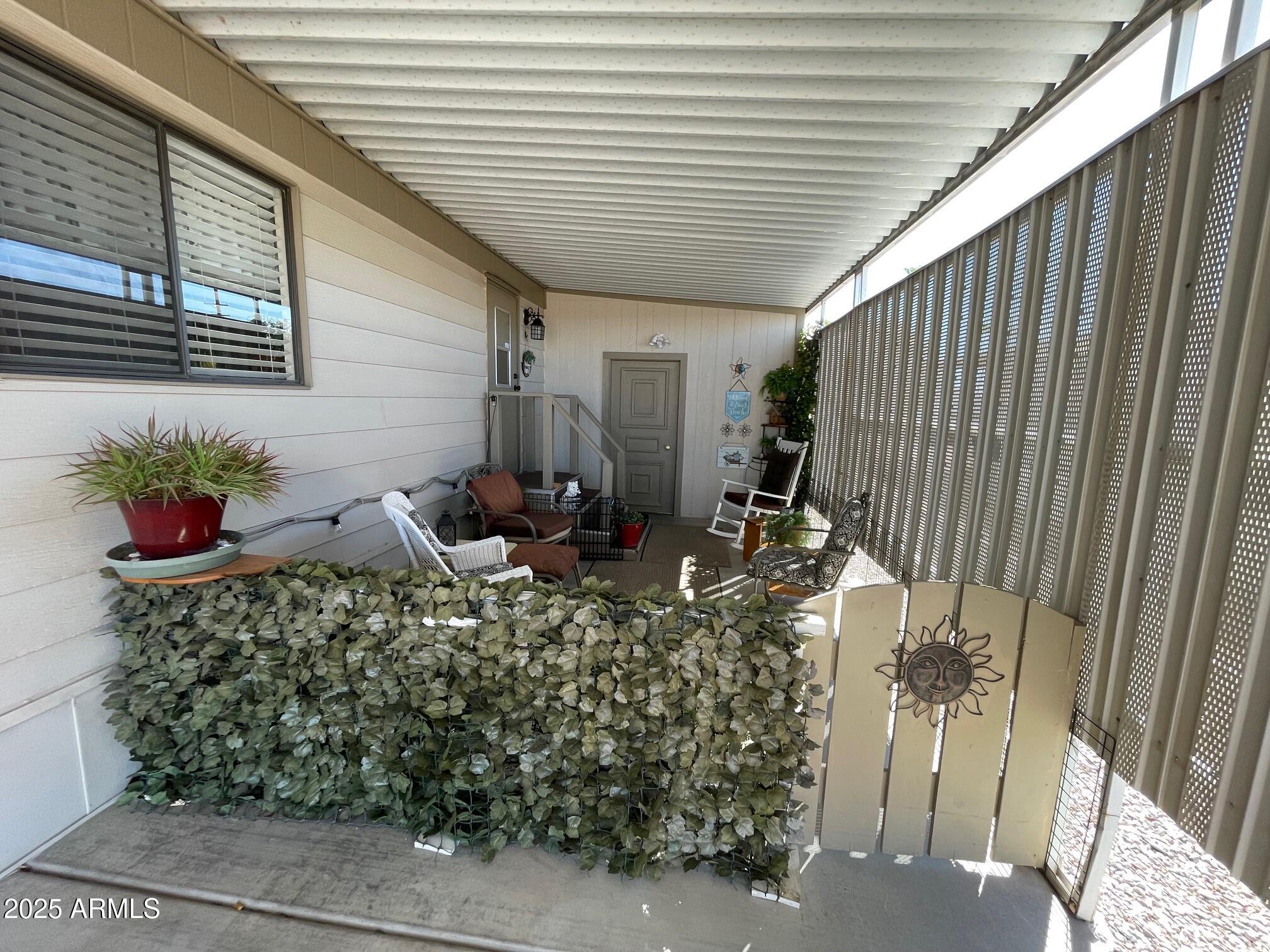 980 East Broadway Avenue, Unit 15 Apache Junction, AZ 85119 - Photo 18 of 24 a potted plant sitting in front of a house