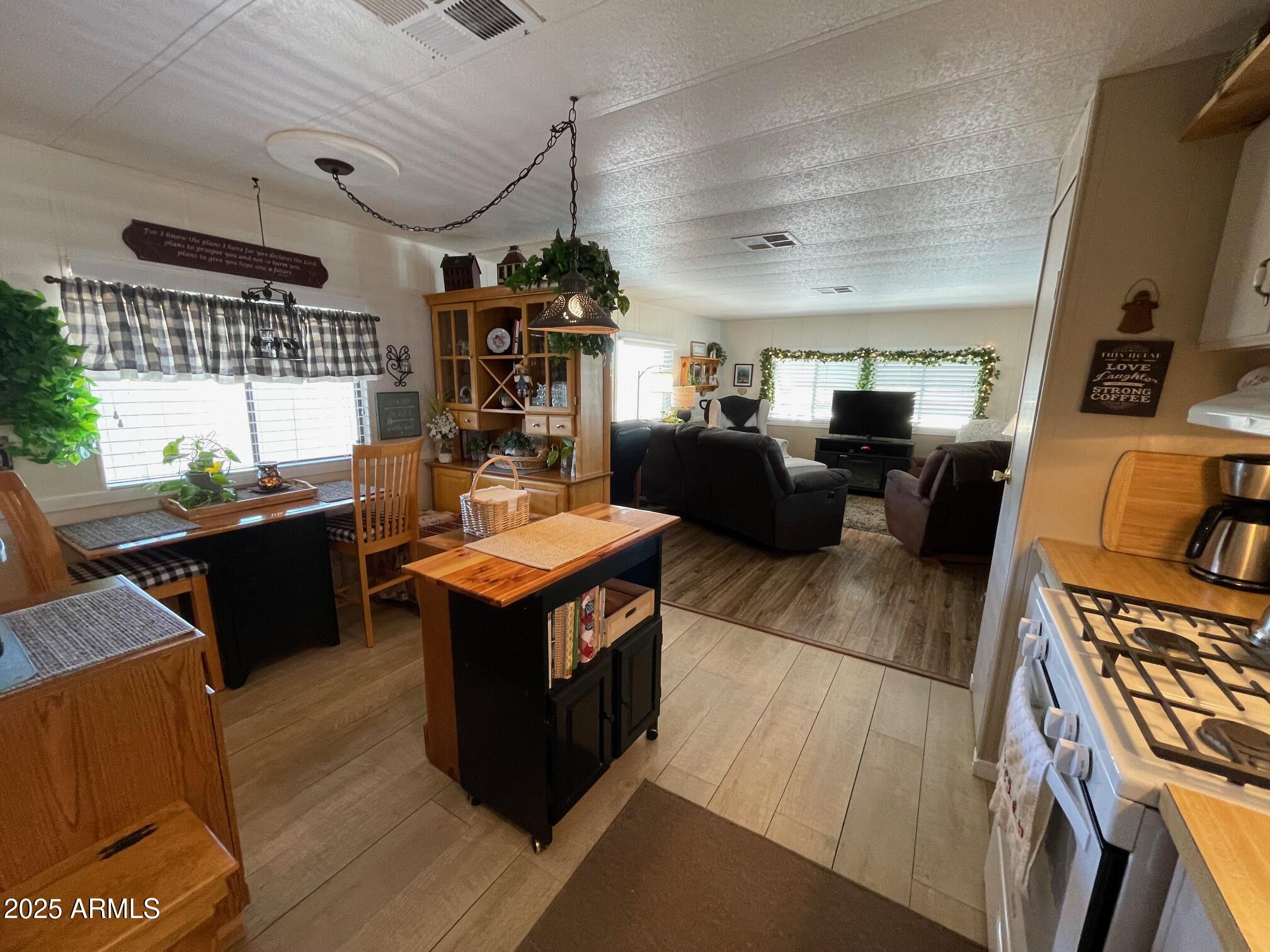 980 East Broadway Avenue, Unit 15 Apache Junction, AZ 85119 - Photo 8 of 24 a kitchen with a stove and a refrigerator