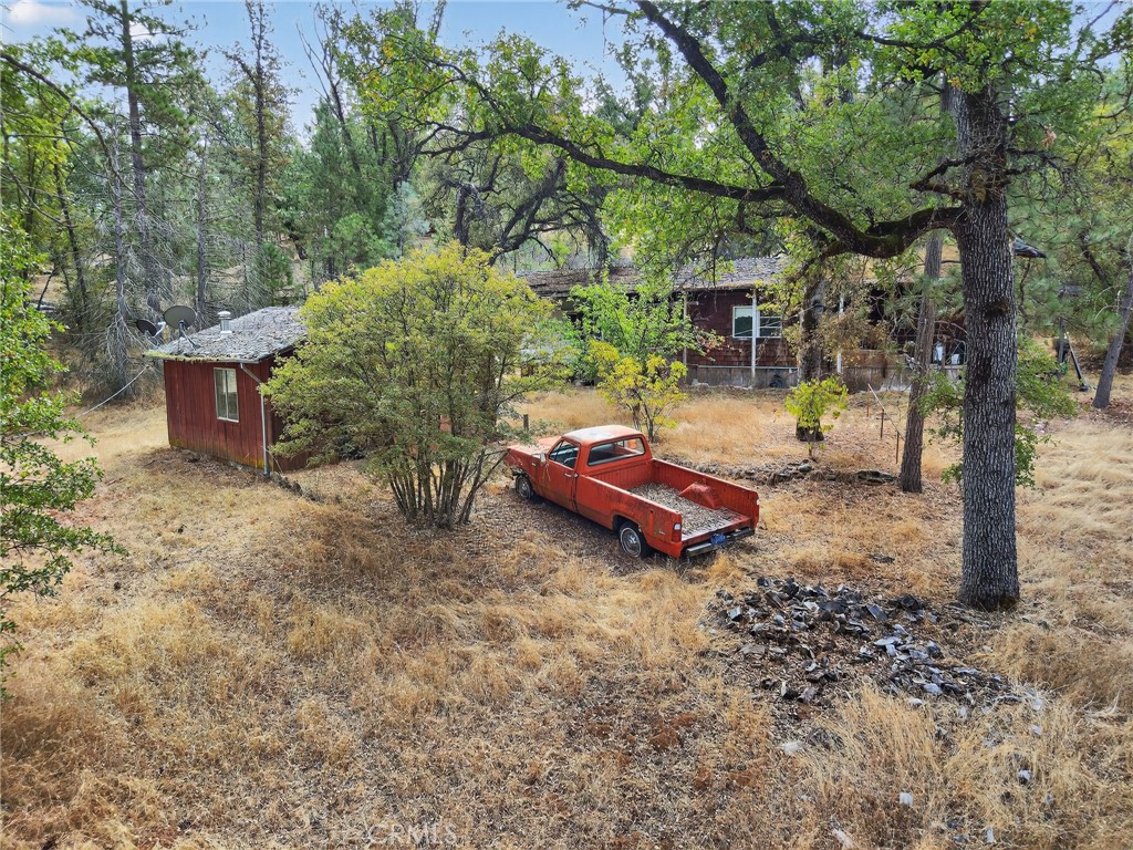 5021 Colorado Road Midpines, CA 95345 - Photo 11 of 12 a backyard of a house with barbeque oven table and chairs
