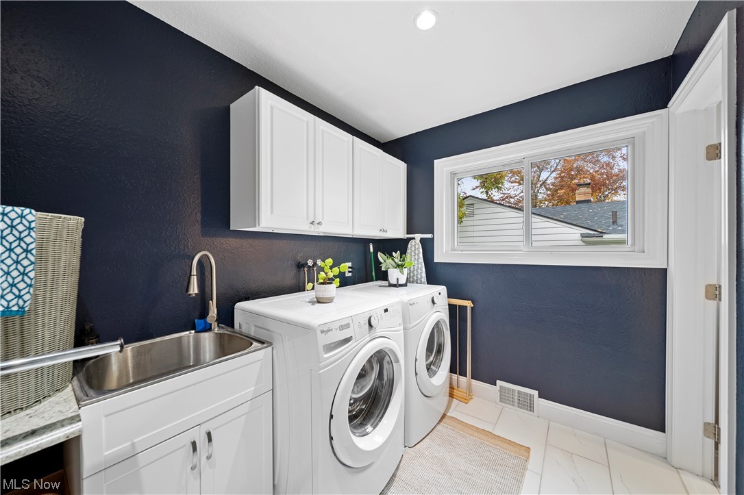 6258 Fairhaven Road Cleveland, OH 44124 - Photo 24 of 35 First Floor Laundry area with cabinets, side by side washer and dryer, light tile floors, and sink