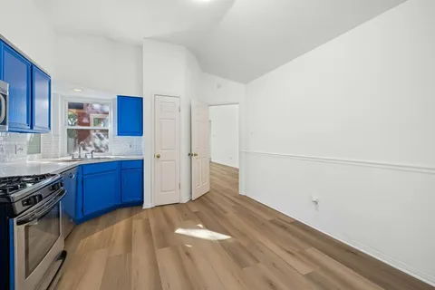 a kitchen with stainless steel appliances granite countertop a refrigerator and a stove top oven