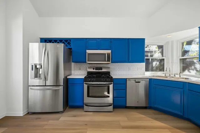 a kitchen with granite countertop stainless steel appliances and wooden cabinets
