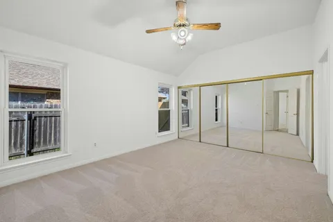 a view of empty room with ceiling fan