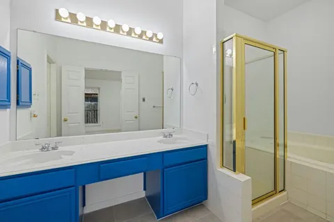 a bathroom with a double vanity sink and a mirror