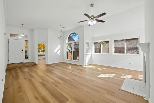 a view of a livingroom with a window and wooden floor