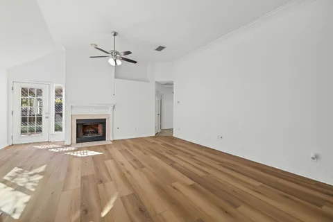 a view of empty room with fan and fireplace