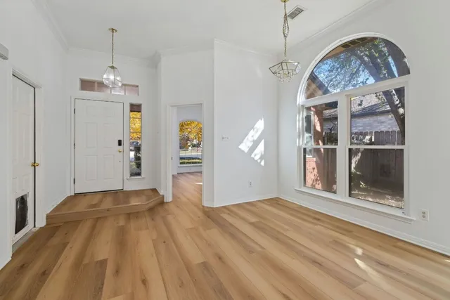a view of a hallway with a chandelier